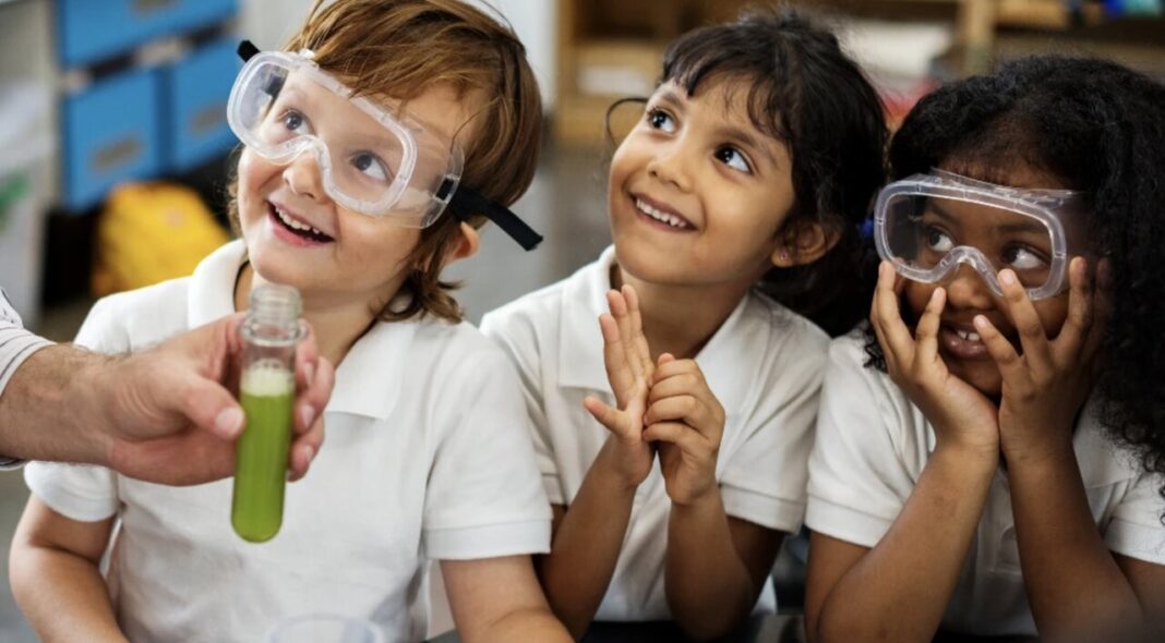 Children looking forward to the future in a chemistry lesson.