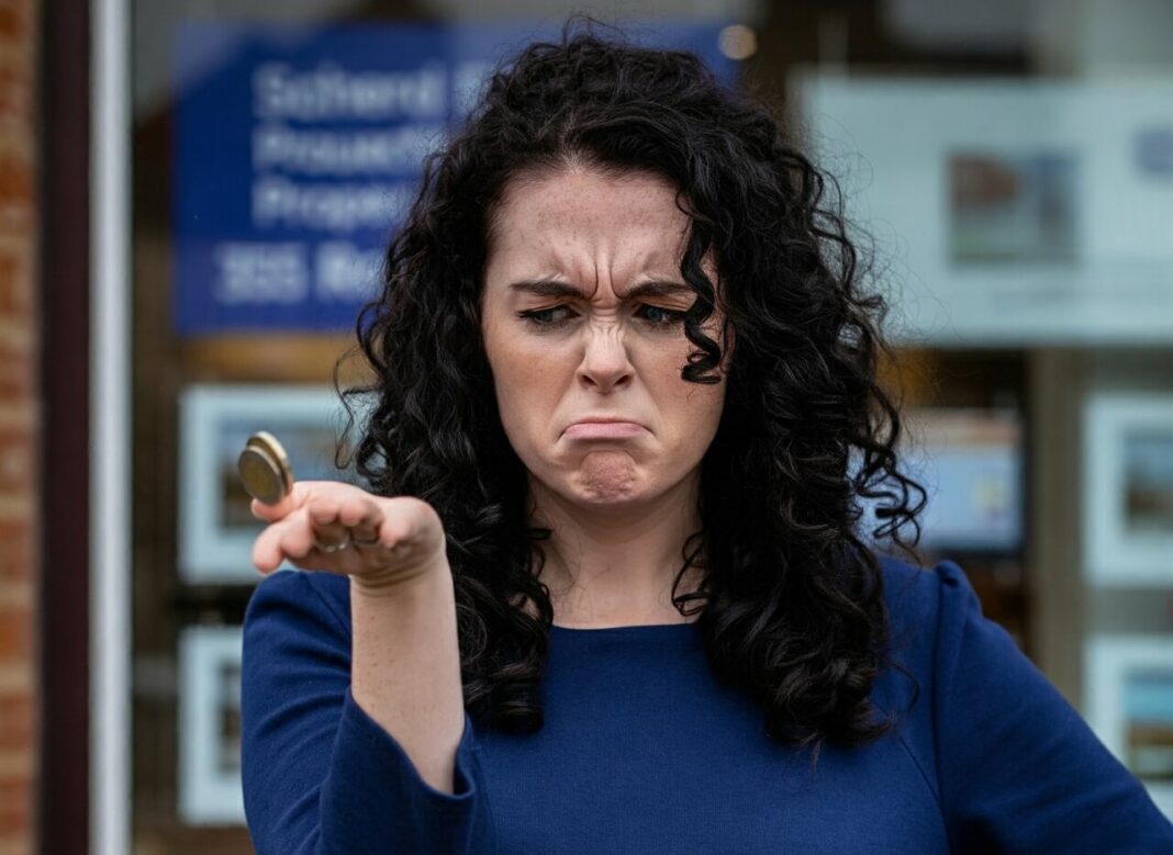 A struggling lady first-time buyer tossing up coins outside an agents office